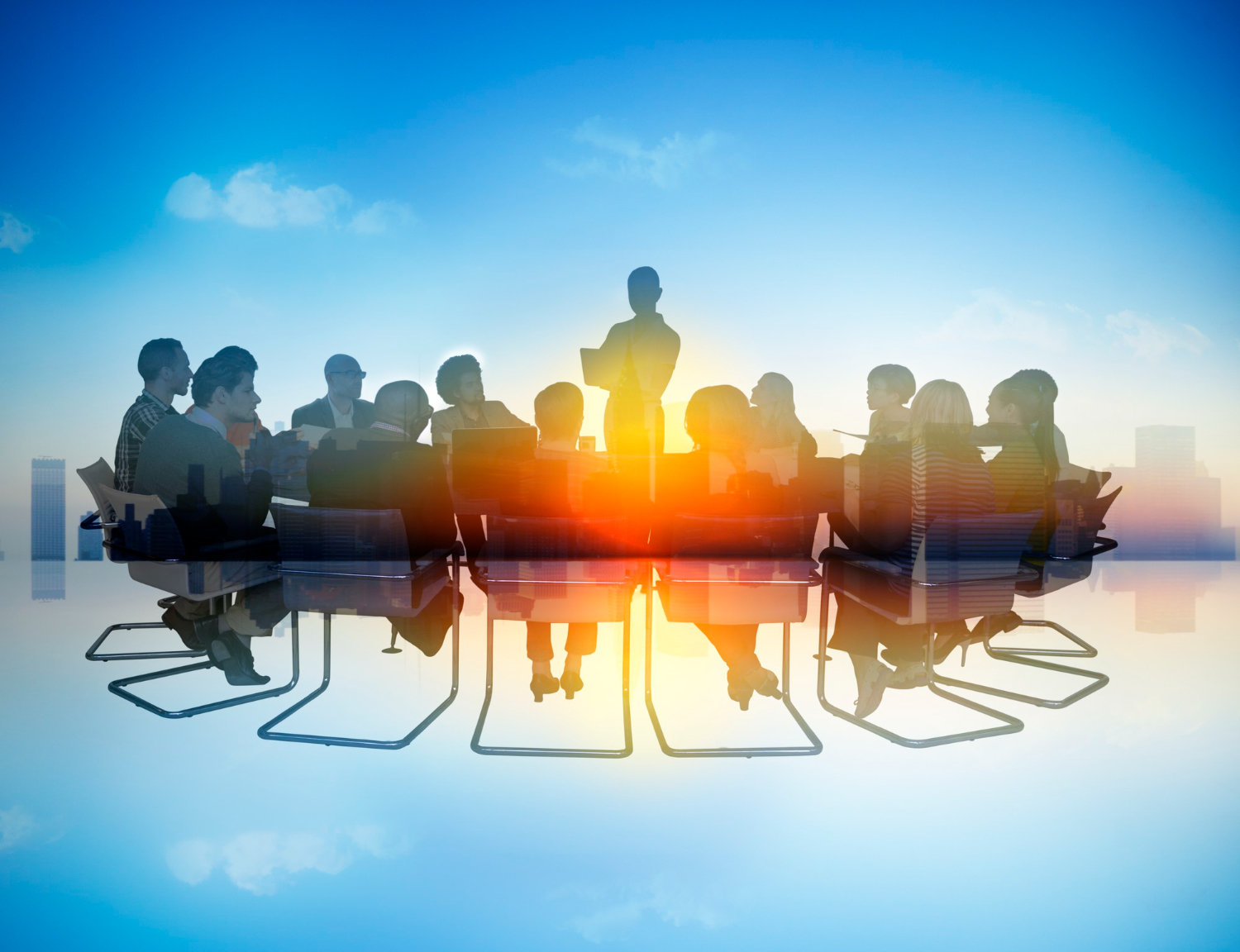 Senior team in discussion around a boardroom table.